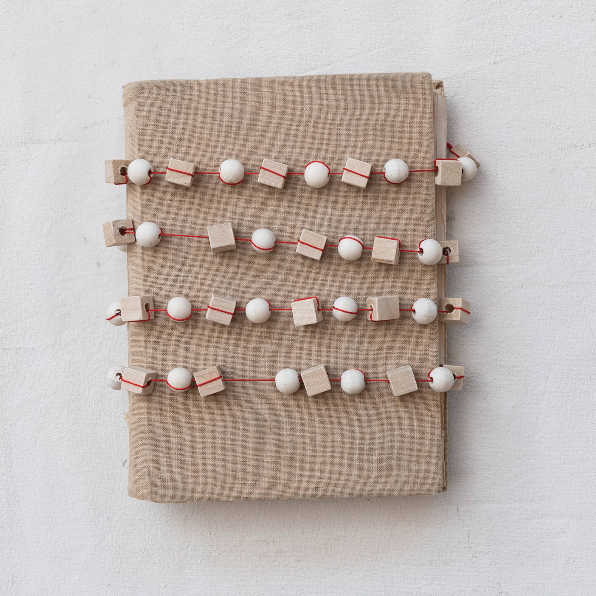 Hello Honey® 6ft. Paulownia Wood Mixed Shapes Beads & Red String Garland